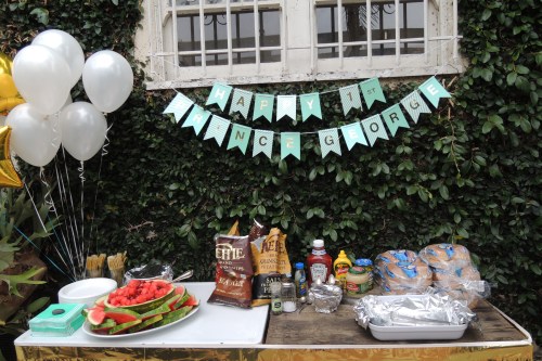 I repeat...SIMPLE...Here is the BBQ table, with a banner, some balloons and a gold fringe table skirt.  