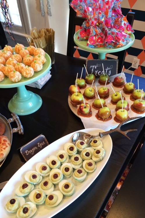 We added avocado to deviled eggs to give them a dragon-y green tinge and olives for pupils.  Peeled mandarins with a bit of celery look just like little pumpkins and half dipped caramel lady apples are easier on small mouths and bellies.  