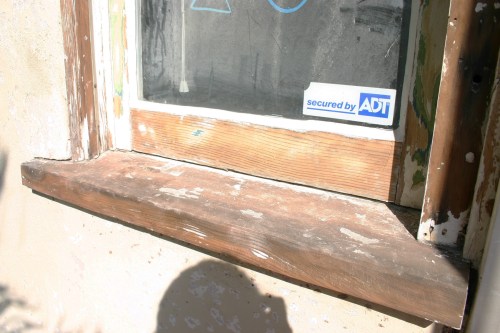 After power washing the house, the painters sanded down the windows. 